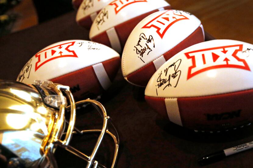 A set of Big 12 footballs are signed by the head coaches during the Big 12 Conference...