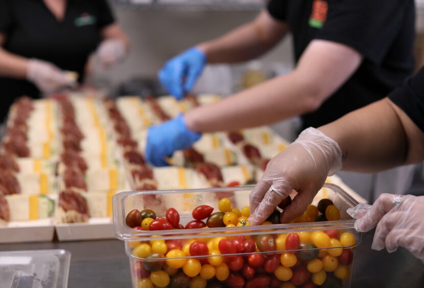 Employees build mini charcuterie boards for a client at Graze Craze in Plano. (Jason...