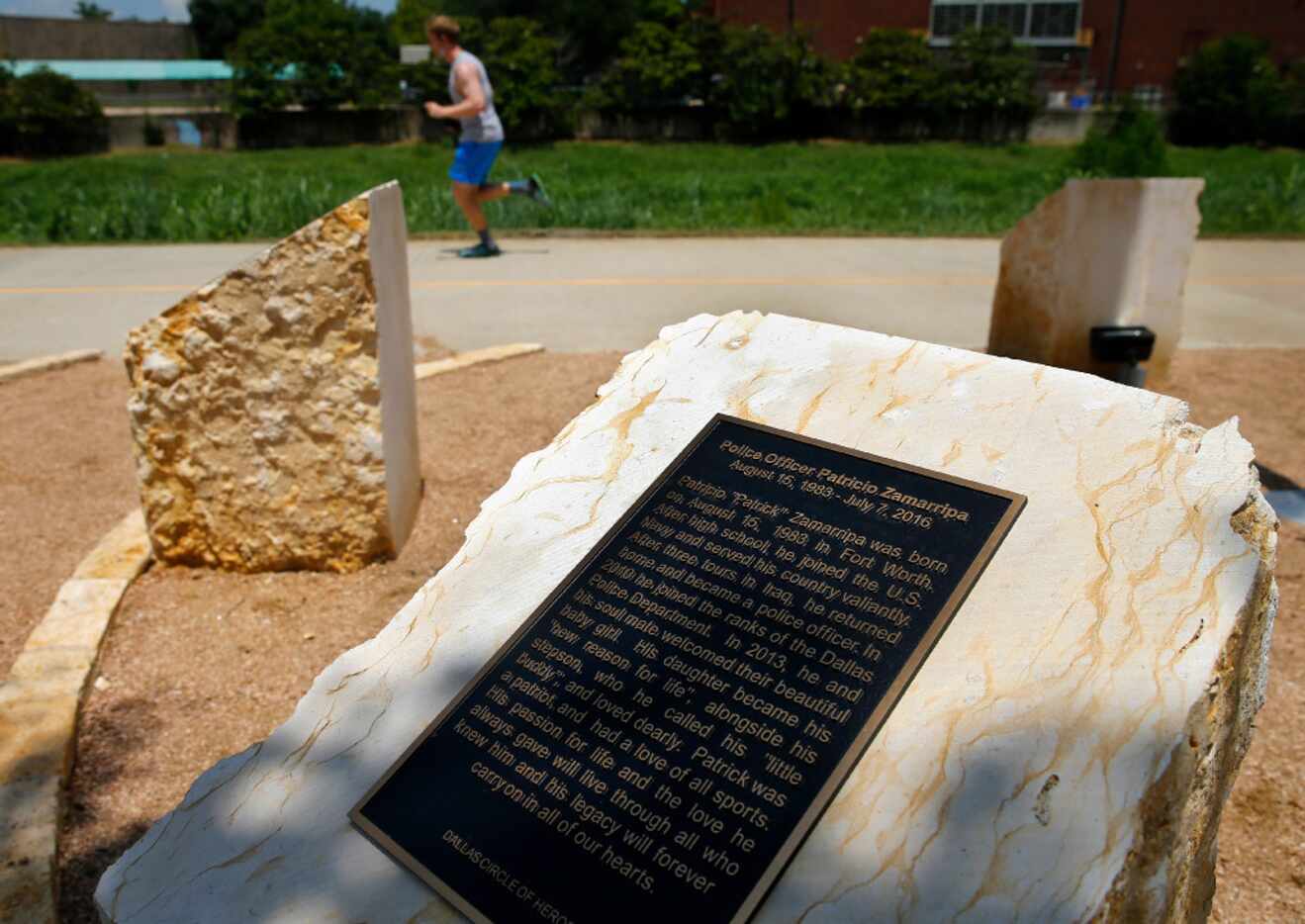 A runner on the Trinity Strand Trail passes the Circle of Heroes memorial unveiled Thursday,...