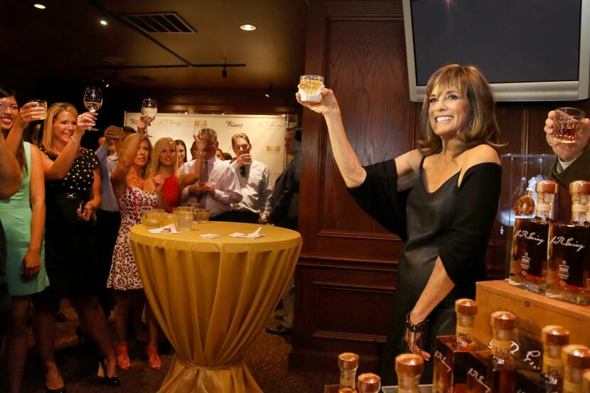Actress Linda Gray toasts former "Dallas"  co-star Larry Hagman at the J.R. Ewing Bourbon...