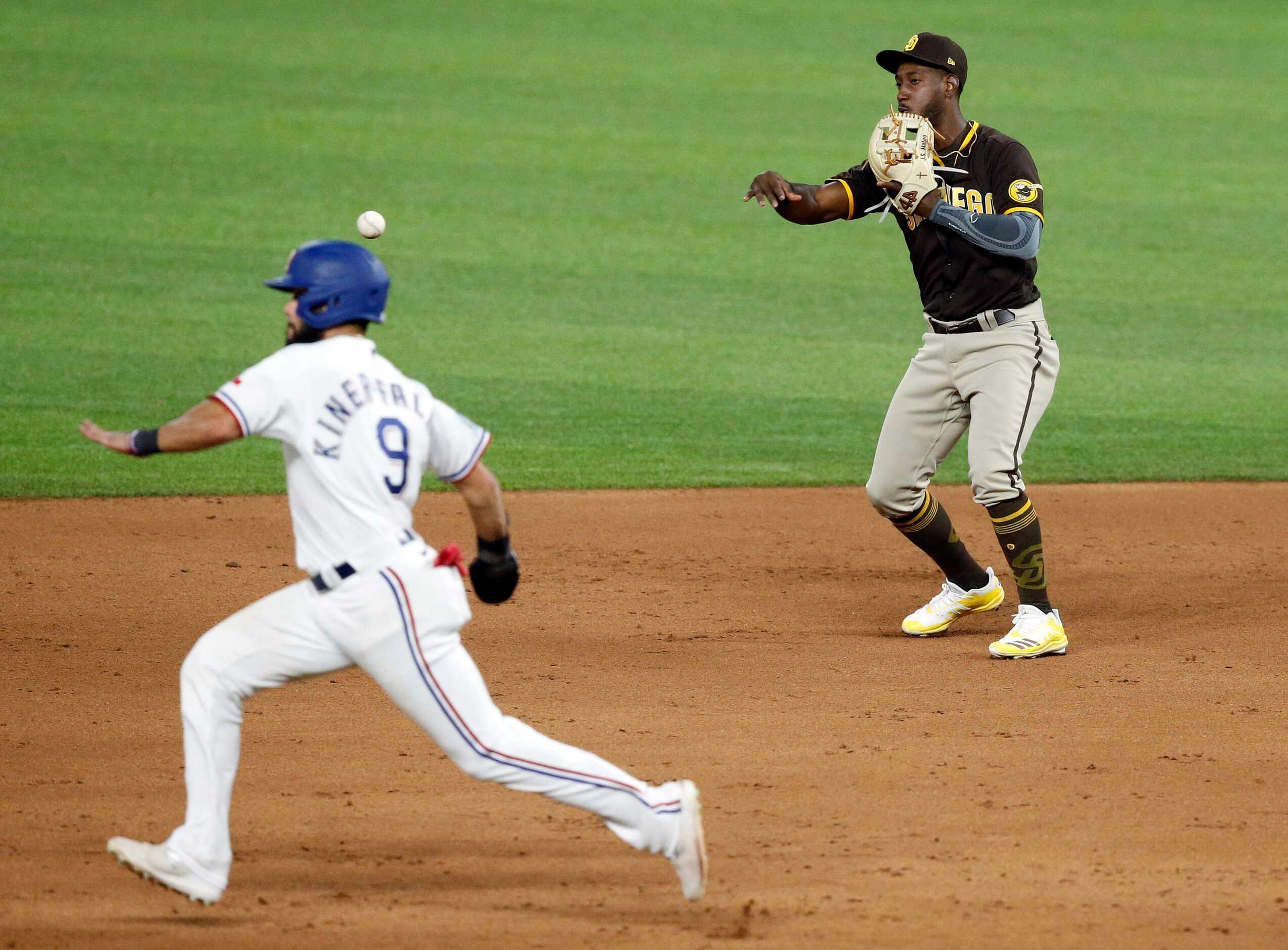 San Diego Padres second baseman Jorge Mateo (right) tosses the ball to second to get Texas...