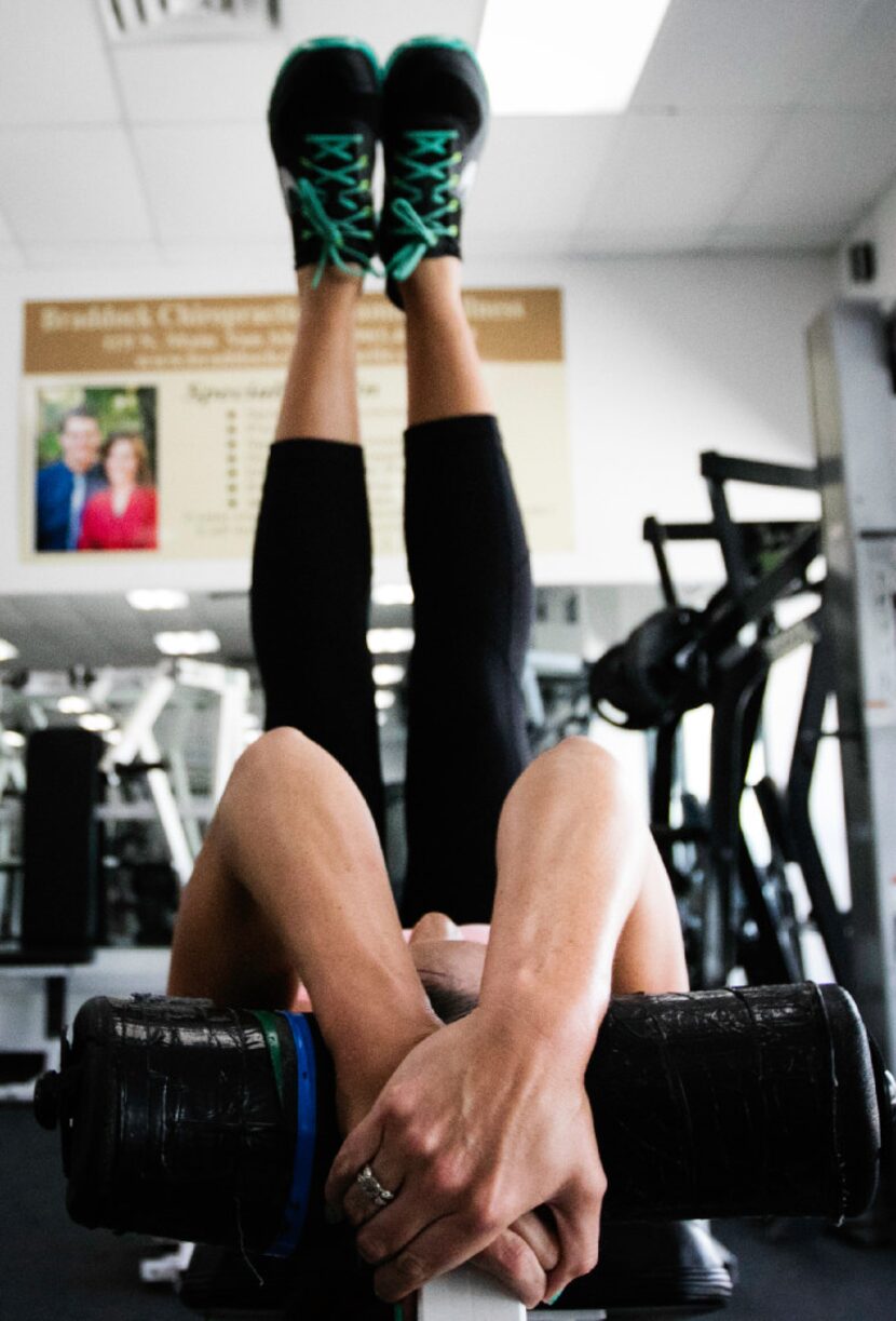 Meagan Florence lifts her legs during her workout at Number 1 Fitness in Howe, Texas.