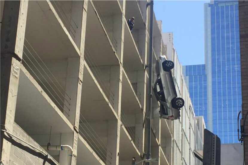 A man drove his car off the top story of a parking garage in downtown Austin. High-tension...