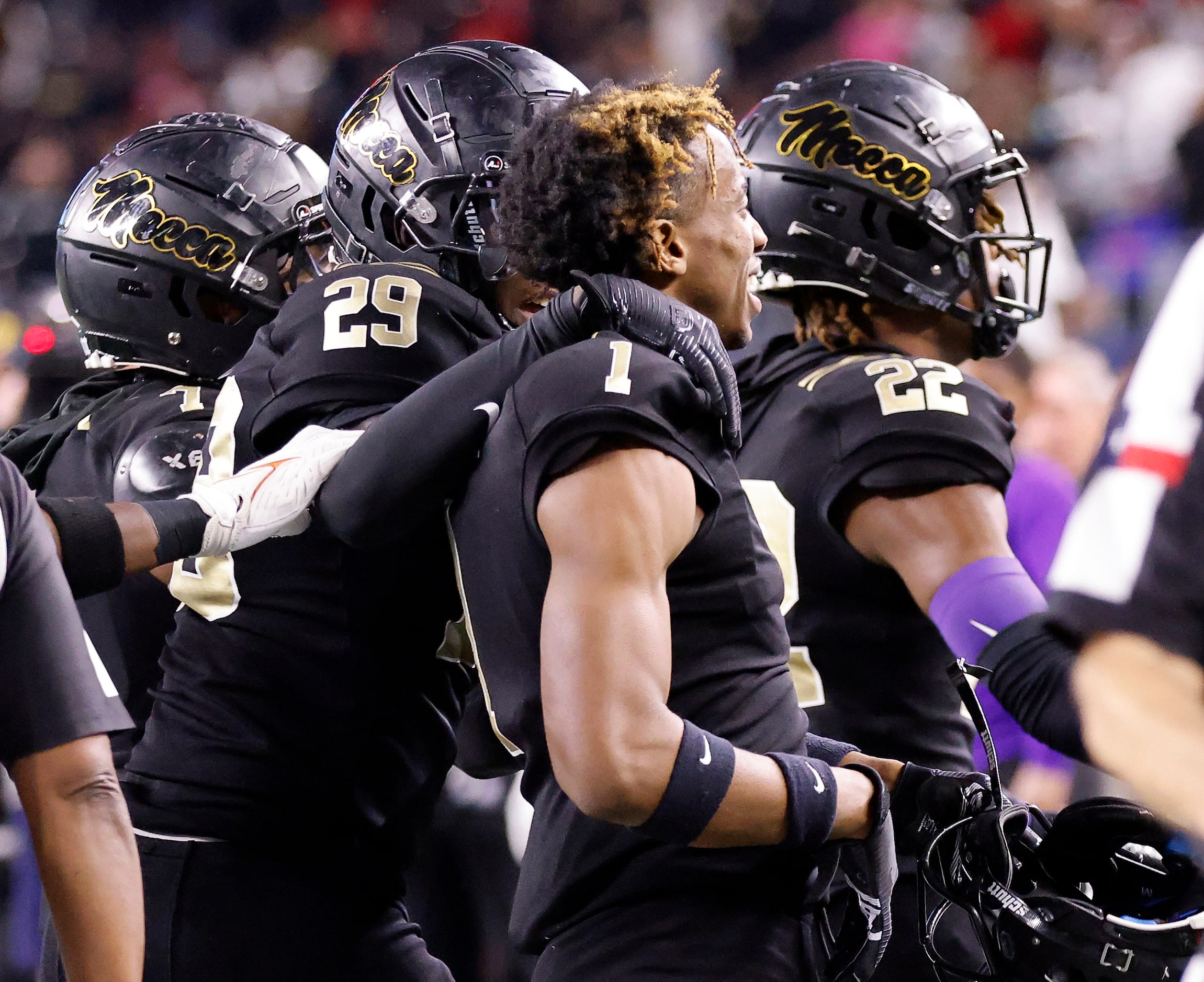 South Oak Cliff players congratulate defensive back Manny Muhammad’s (1) pick 6 during the...