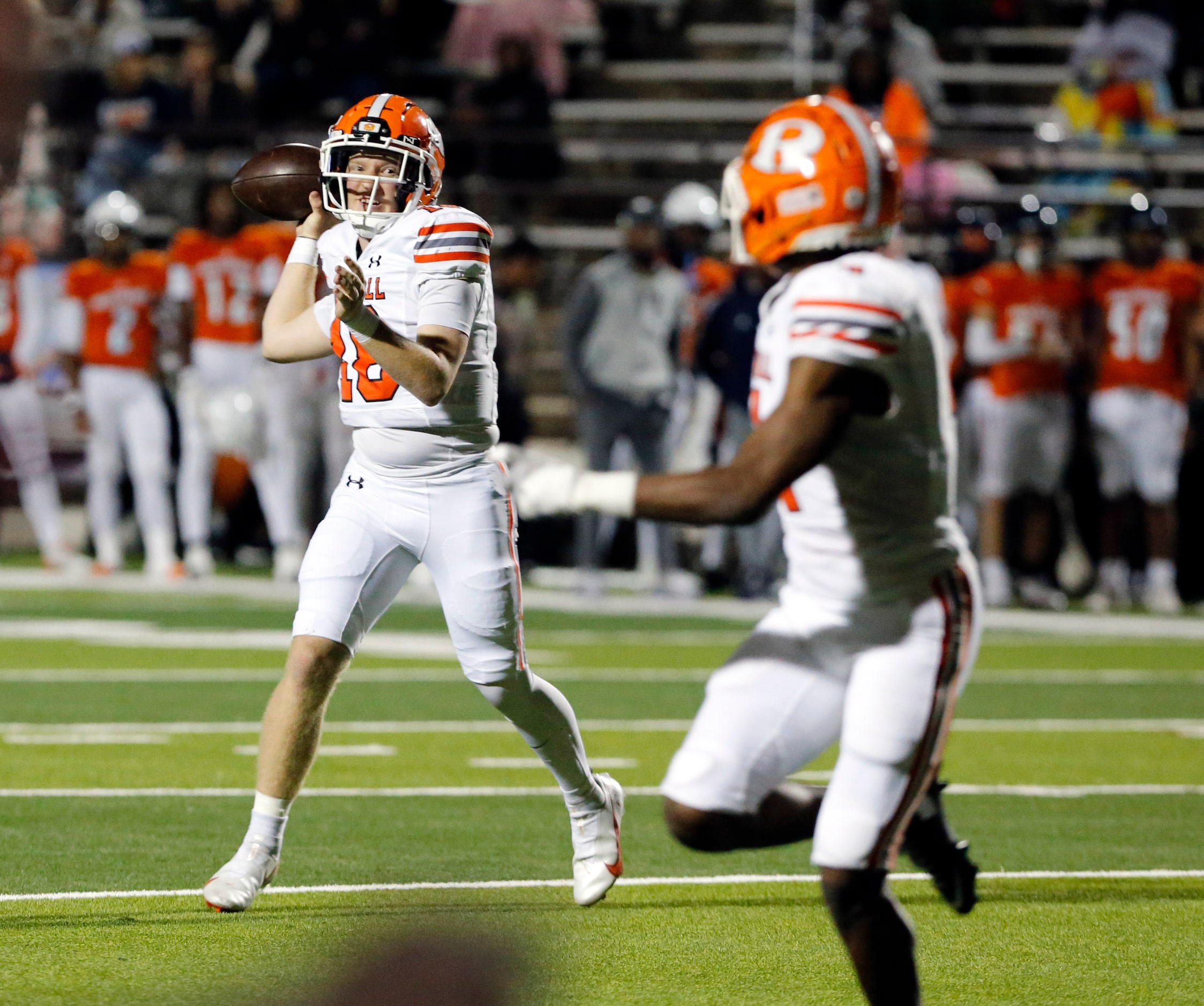 Rockwall High QB Brent Rickert (18) looks downfield for a target during the first half of a...