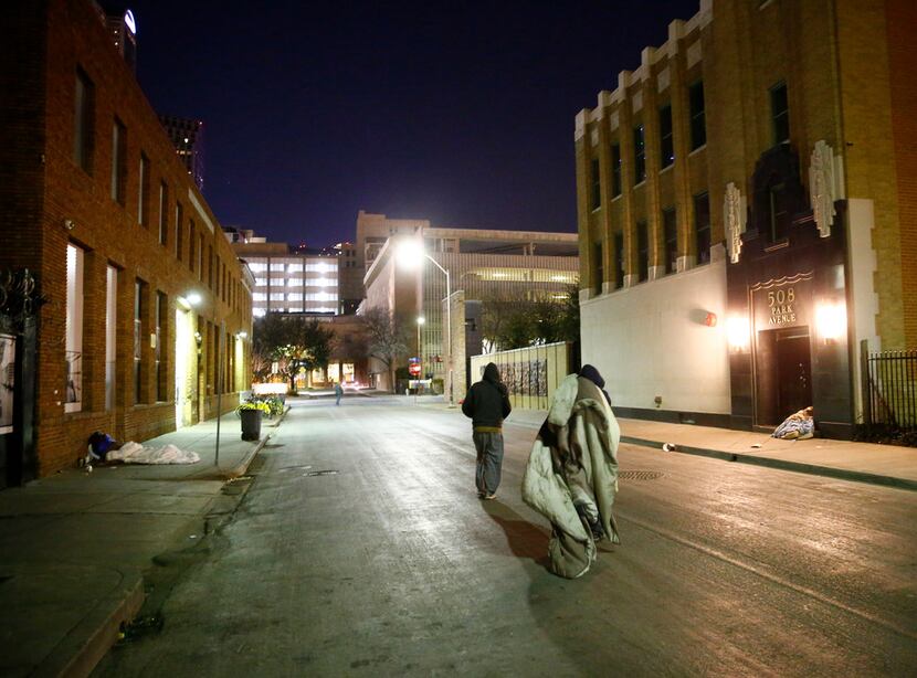 People move their blankets down Park Avenue next to The Stewpot in downtown Dallas on Jan....