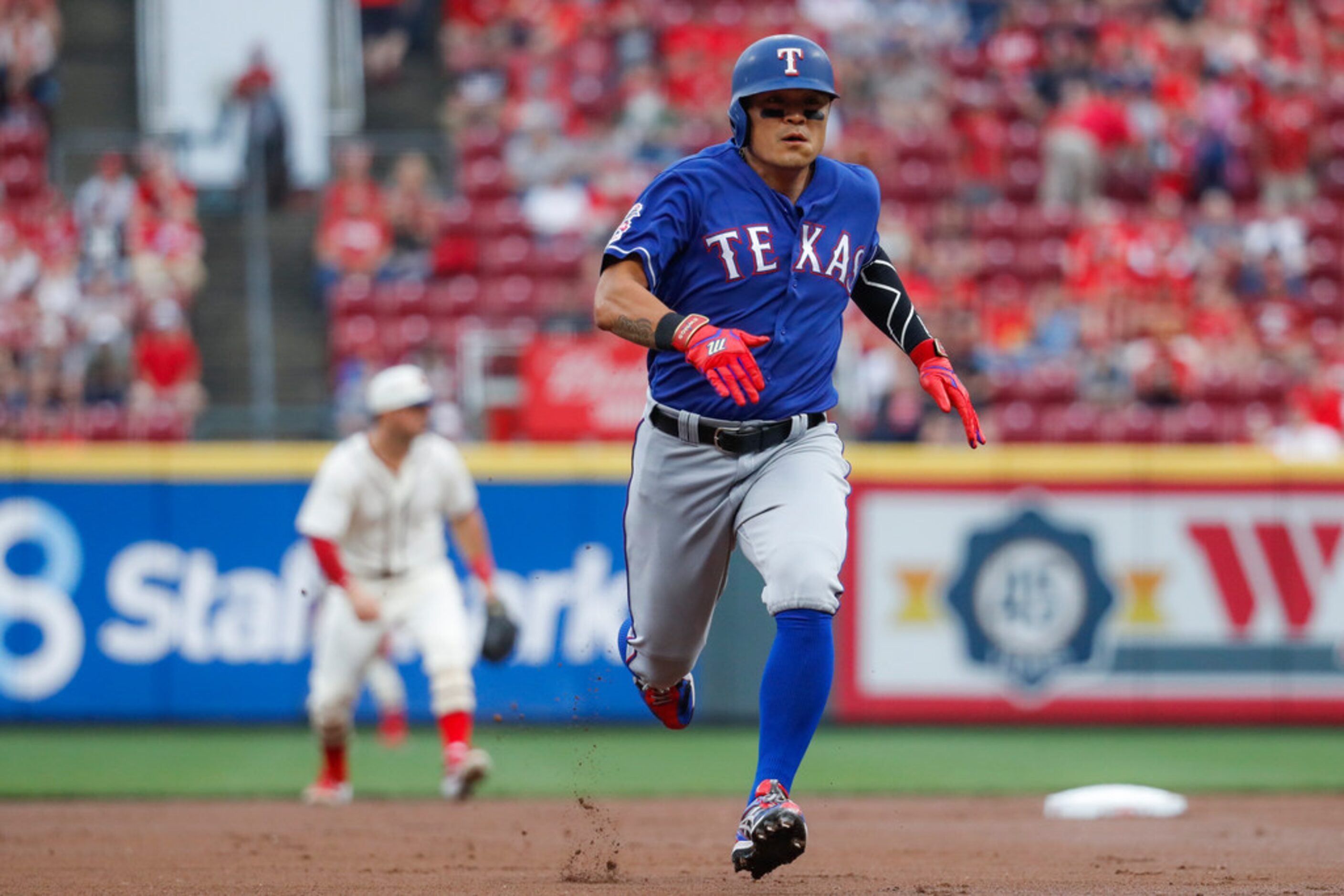 Texas Rangers' Shin-Soo Choo runs to third on a single by Danny Santana off Cincinnati Reds...