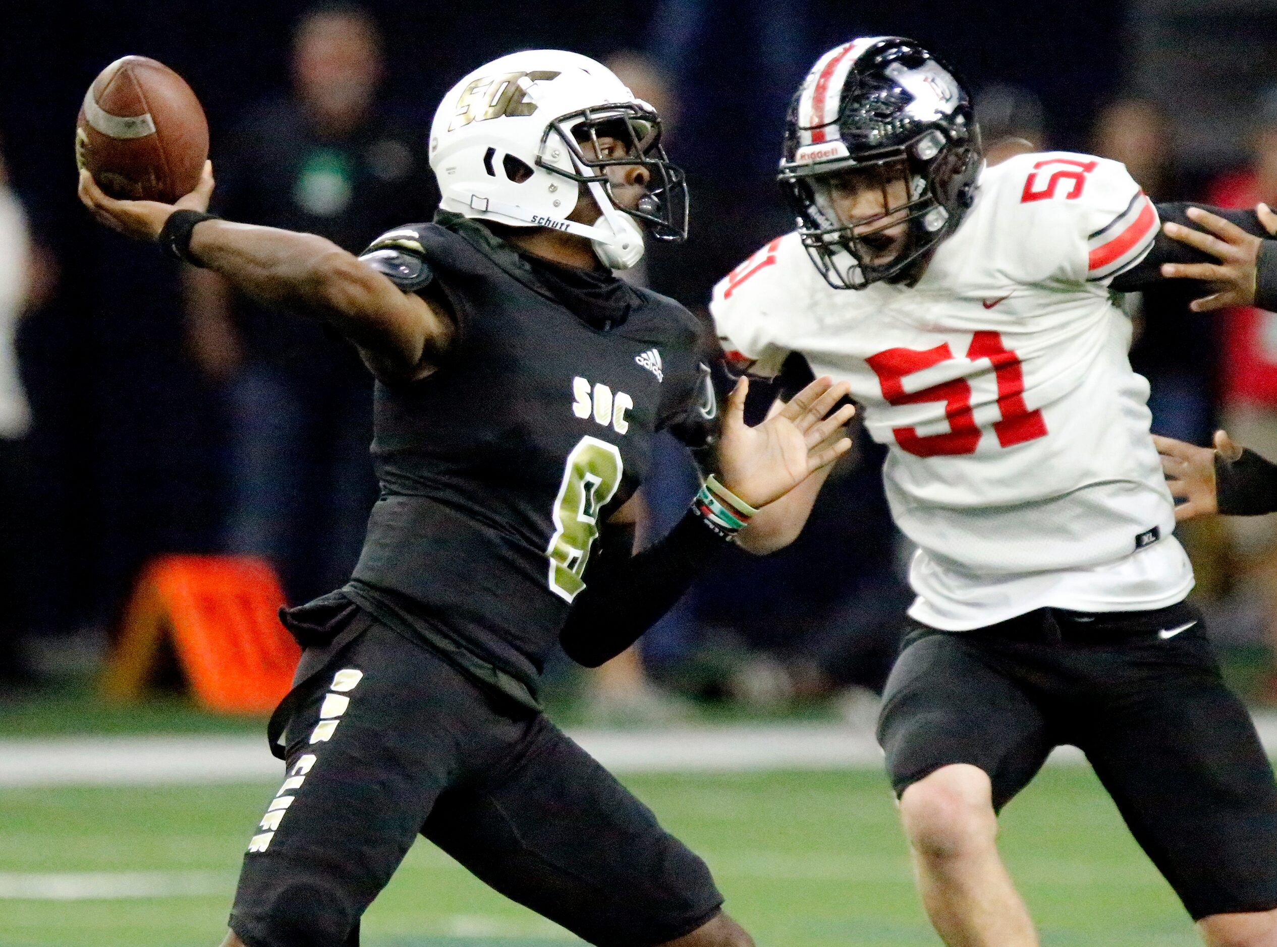 South Oak Cliff High School quarterback Kevin Henry-Jennings (8) throws a pass in front of...