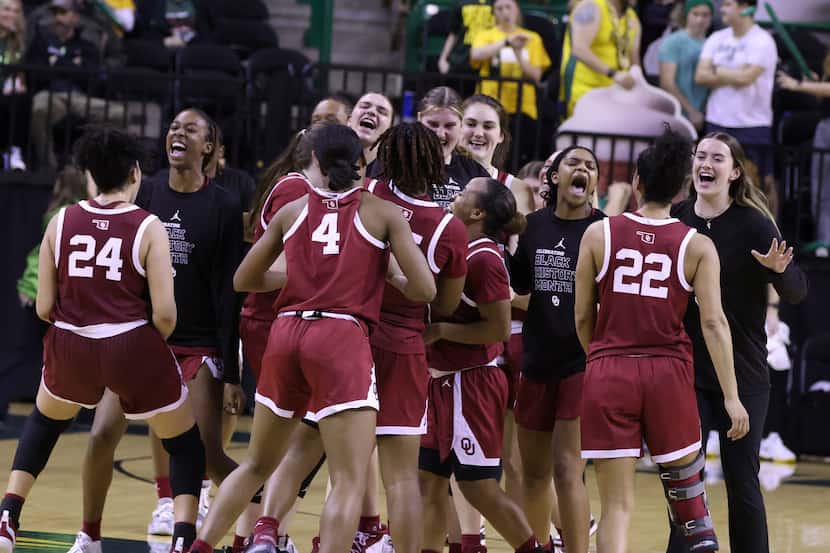 Oklahoma players celebrate their overtime win over Baylor in an NCAA college basketball game...