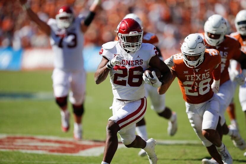 Oklahoma running back Kennedy Brooks (26) breaks past the Texas defense to score the game...