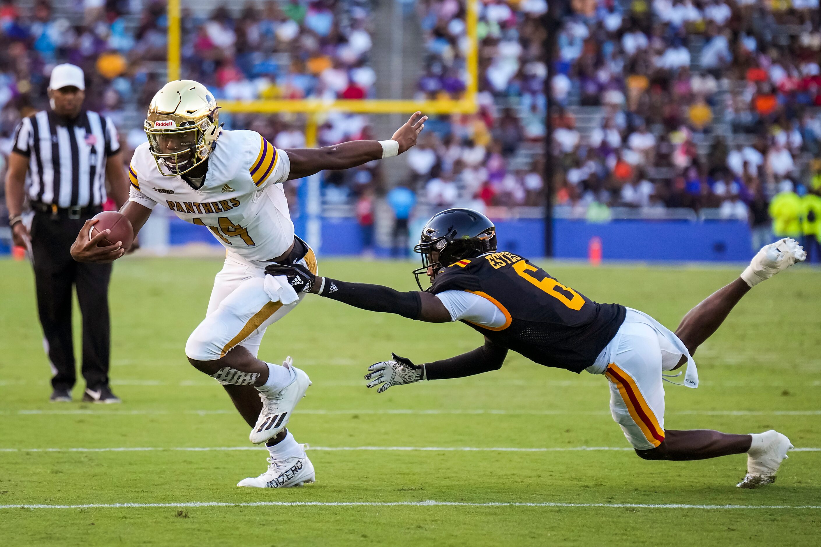 Prairie View quarterback Trazon Connley (14) gets past Grambling defensive back Reyondous...