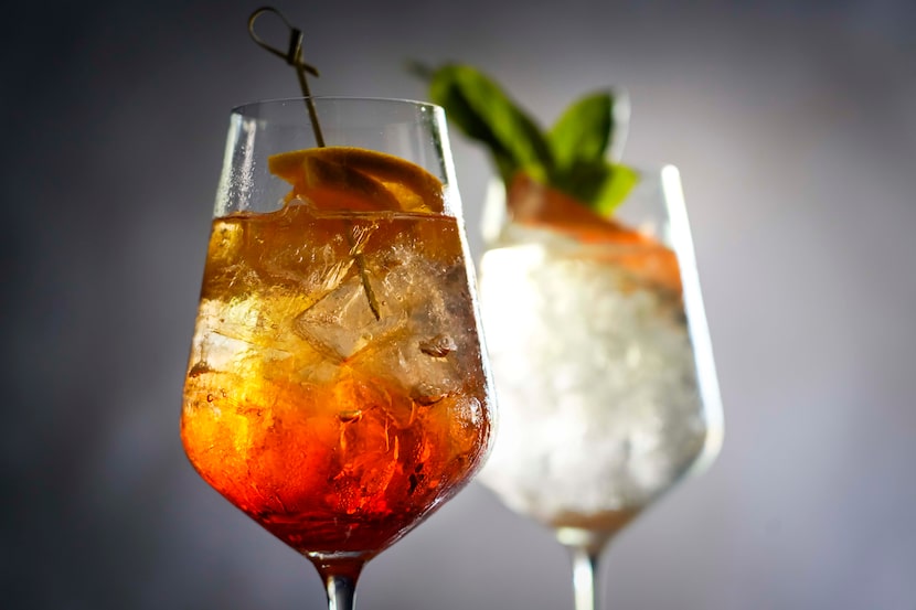 An Aperol Spritz, with orange wheel garnish (left), and Pompelmo Spritz (grapefruit spritz)...