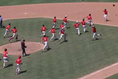 Grapevine players storm the field to congratulate first baseman Jarett Boswell (12), upper...