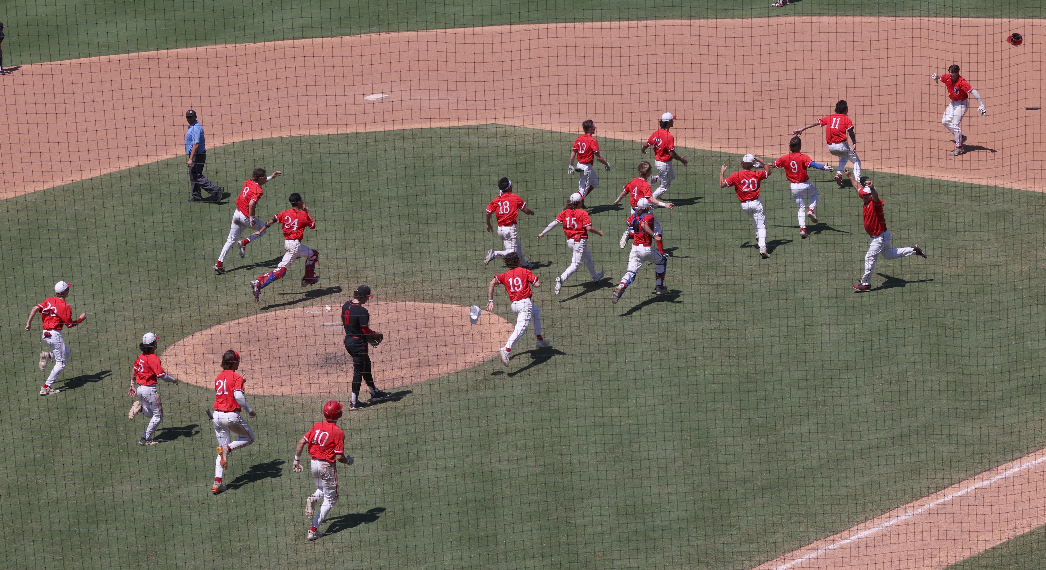 Grapevine players storm the field to congratulate first baseman Jarett Boswell (12), upper...