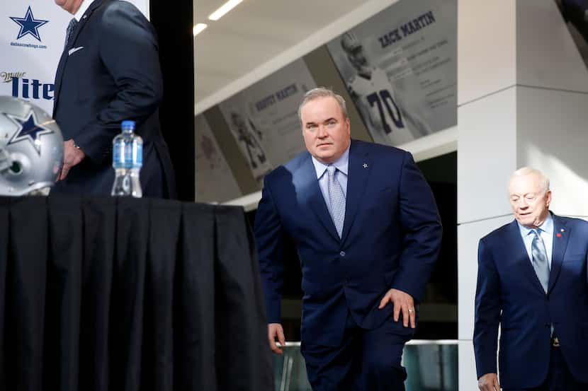 FILE - Cowboys head coach Mike McCarthy makes his way to the stage before a press conference...