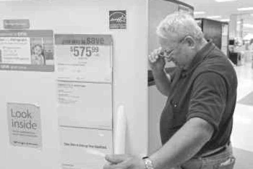  Bill Quinn of Combine, Texas, looked at Energy Star models at Sears on Wednesday in Town...