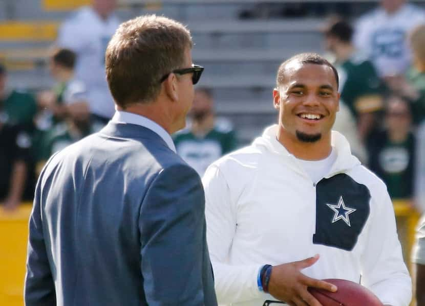 Former Dallas quarterback Troy Aikman, left, and Cowboys quarterback Dak Prescott, right,...