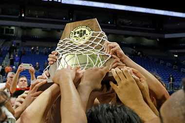 Plano East celebrates with its trophy after defeating Round Rock Stony Point 53-41 in the...