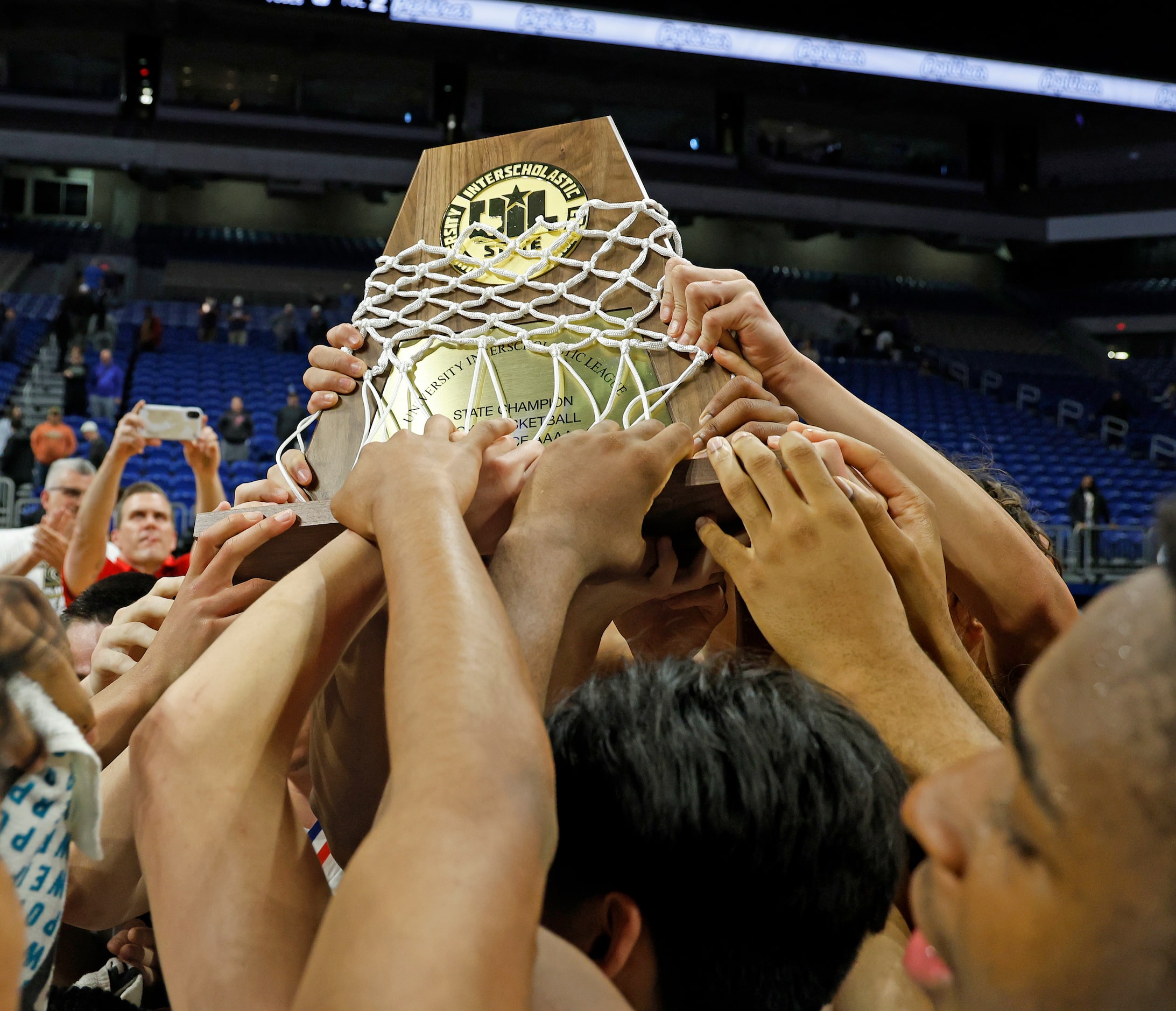 Plano East celebrates with its trophy after defeating Round Rock Stony Point 53-41 in the...