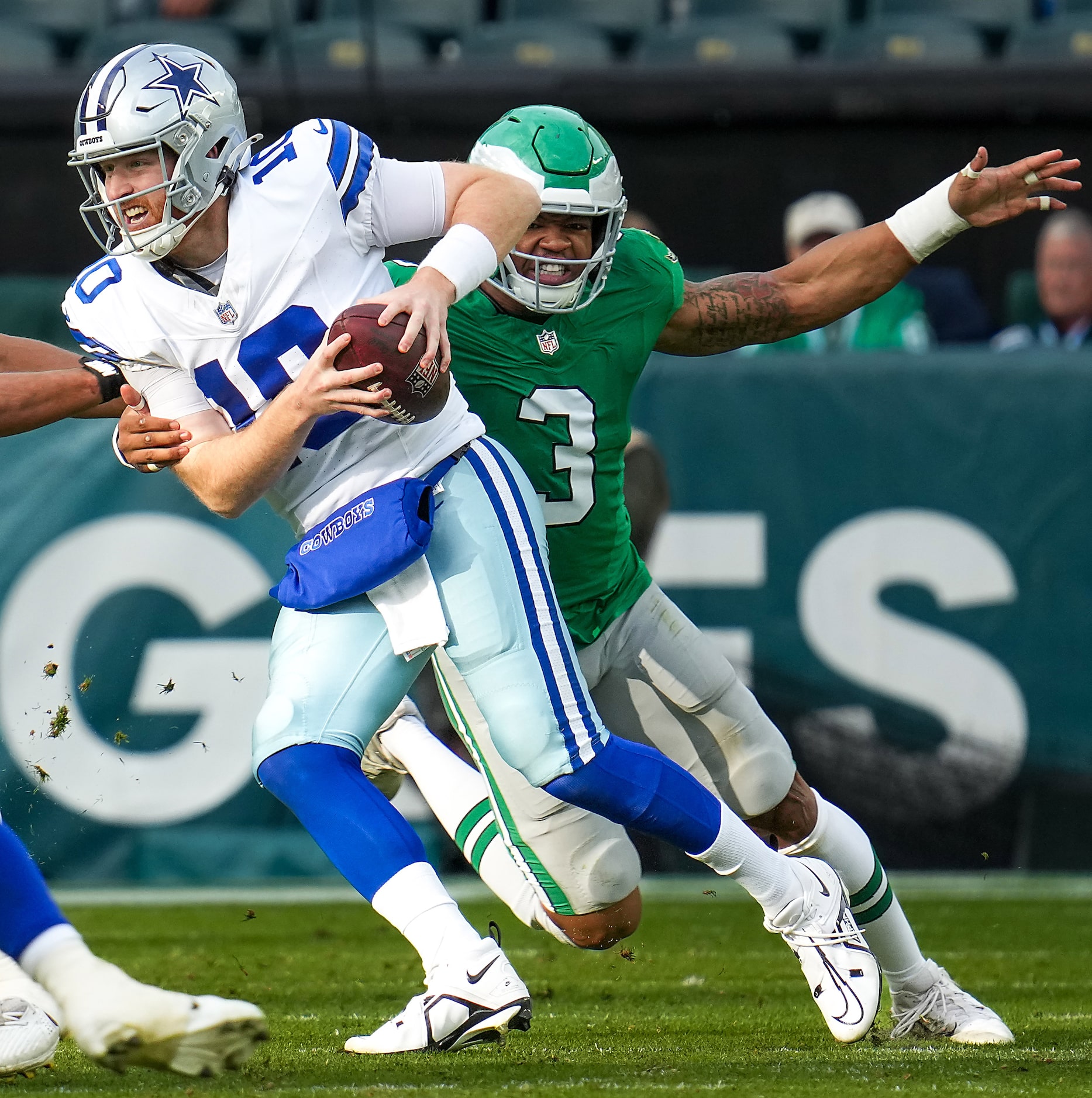 Dallas Cowboys quarterback Cooper Rush (10) is chased down by Philadelphia Eagles linebacker...