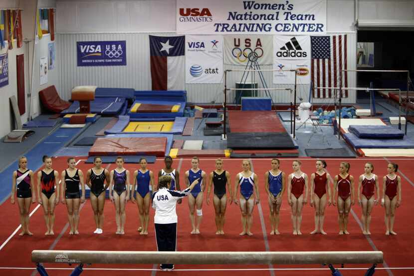 ORG XMIT: *S0423169090* Gymnasts, including Nastia Liukin (far left), line up on the floor...