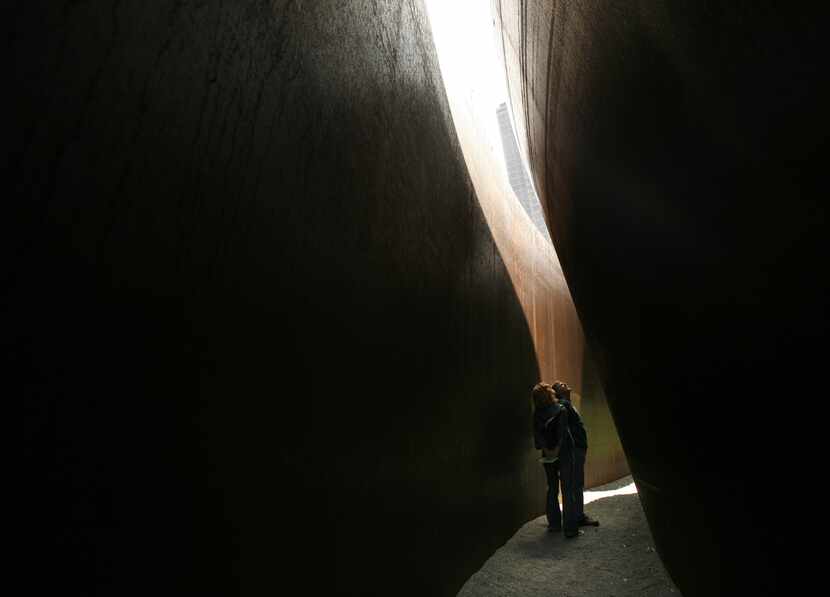 Visitors Allyson Mehling and her father Joe gaze up through the gap of Richard Serra's 'My...
