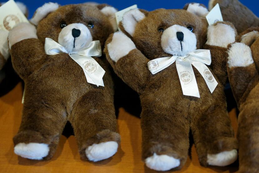 Teddy bears sit on the table during a press conference at Grand Prairie Police Department in...