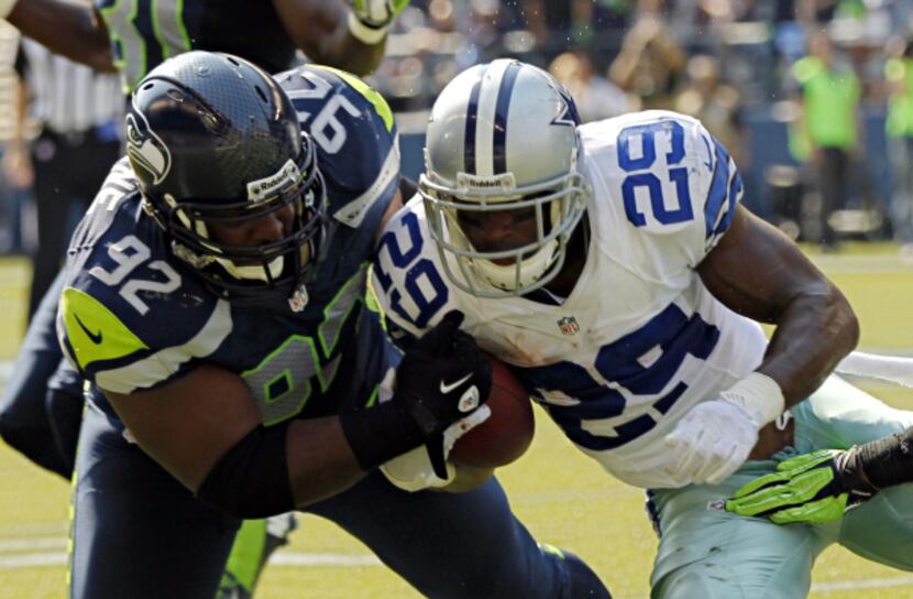 Seattle Seahawks defensive tackle Brandon Mebane (92) nearly strips the ball from Dallas...
