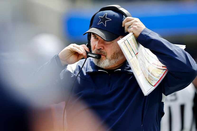 Dallas Cowboys head coach Mike McCarthy readies his headset as he prepares to face the Los...