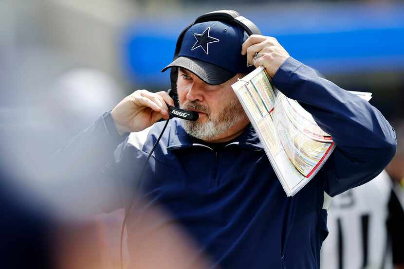Dallas Cowboys head coach Mike McCarthy readies his head set as he prepares to face the Los...