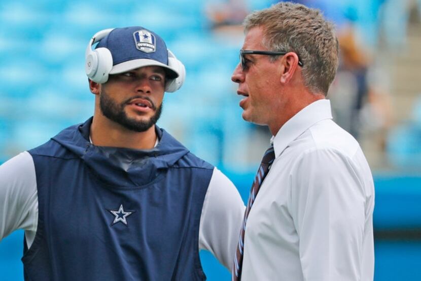 Dallas Cowboys quarterback Dak Prescott (4) talks with TV analyst troy Aikman before the...