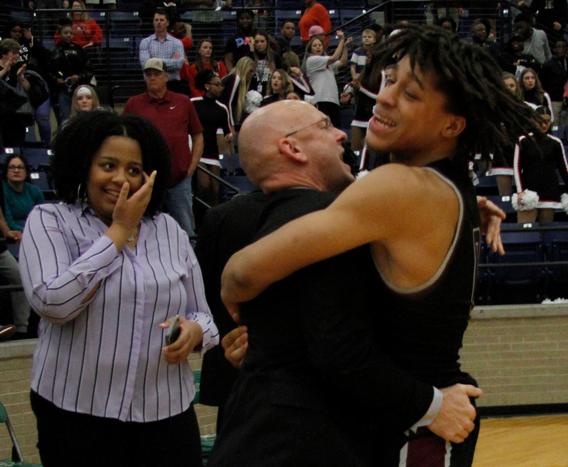 Mansfield Timberview head coach Duane Gregory shares an emphatic hug with Wolves senior...