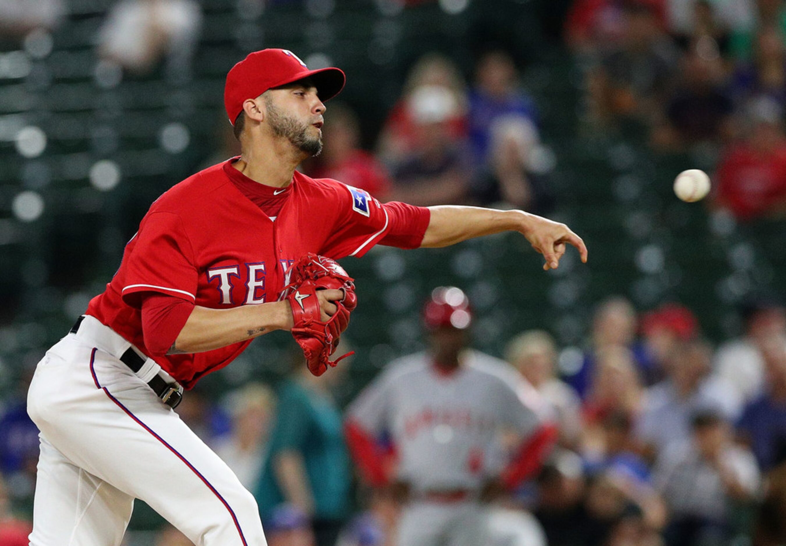 ARLINGTON, TX - SEPTEMBER 03:  Alex Claudio #58 of the Texas Rangers pitches in the ninth...