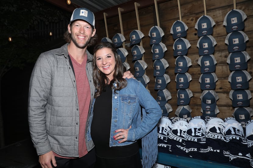 Clayton Kershaw and Ellen Kershaw pose in front of Kershaw's Challenge merchandise at the...
