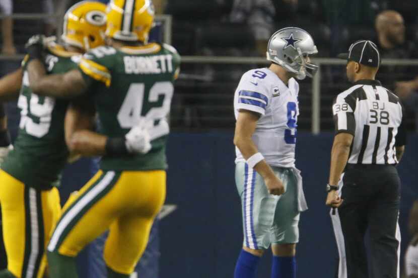 Dallas Cowboys quarterback Tony Romo (9) talks with an official after throwing an...