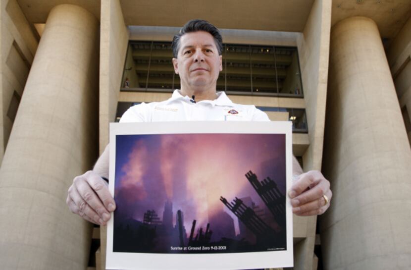 Dallas Fire-Rescue Deputy Chief Daniel DeYear holds a photograph of Ground Zero just days...