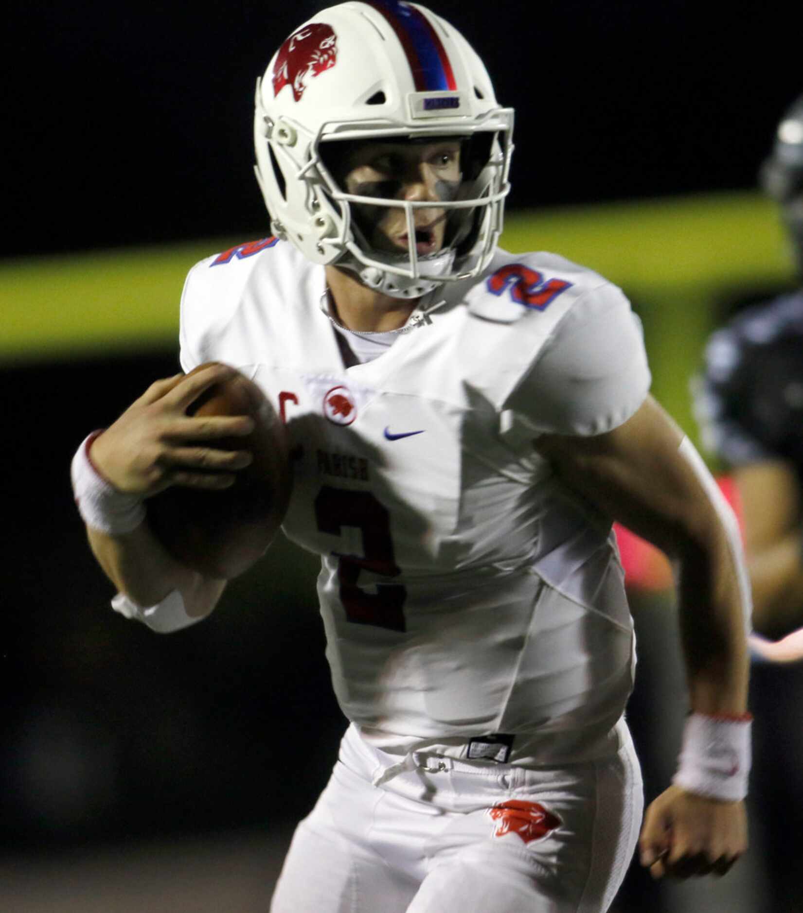 Parish Episcopal  quarterback Preston Stone (2) looks over his shoulder enroute to a long...