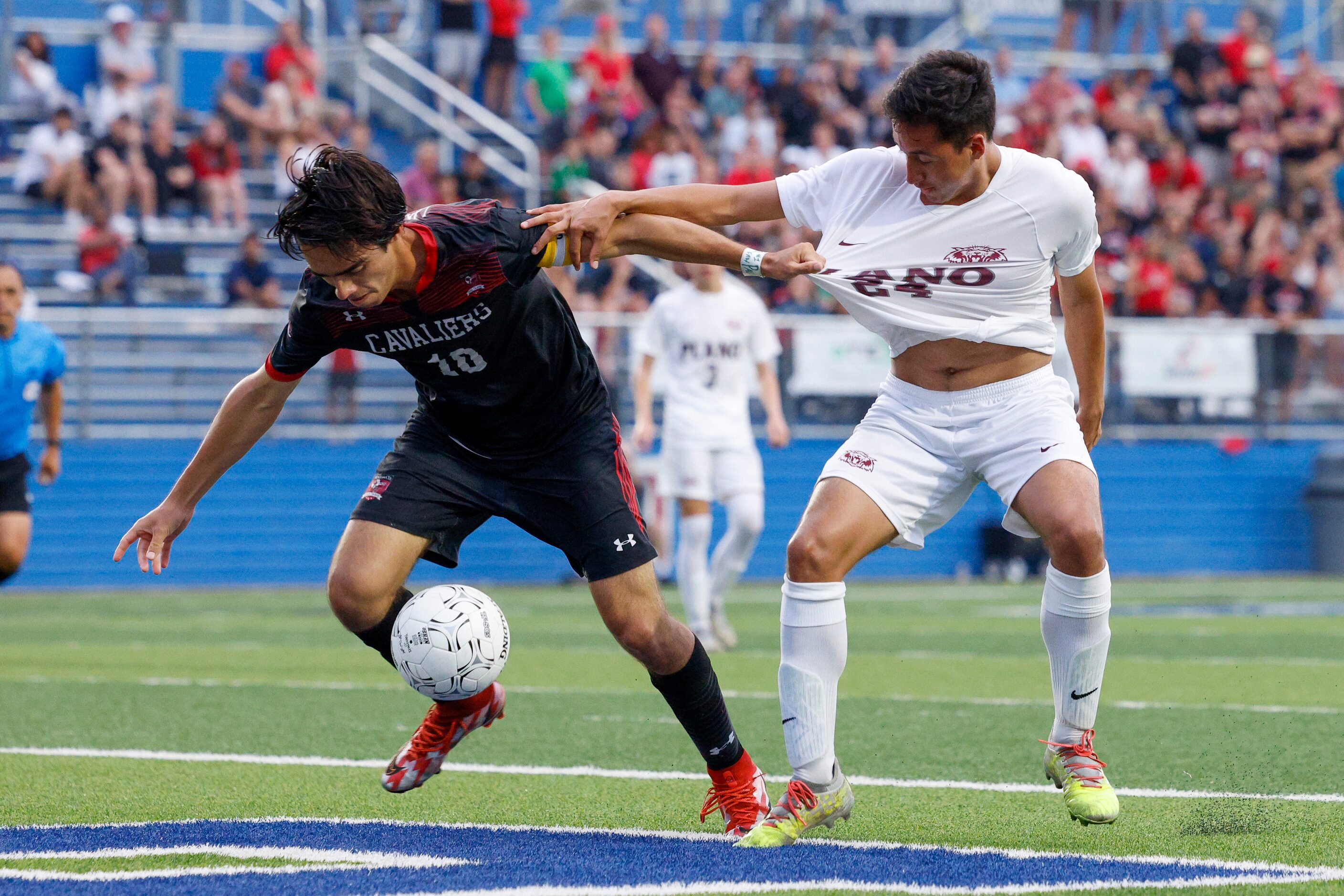 Austin Lake Travis defender Bernie Vargas-Lopez (10) pulls on the jersey of Plano midfielder...