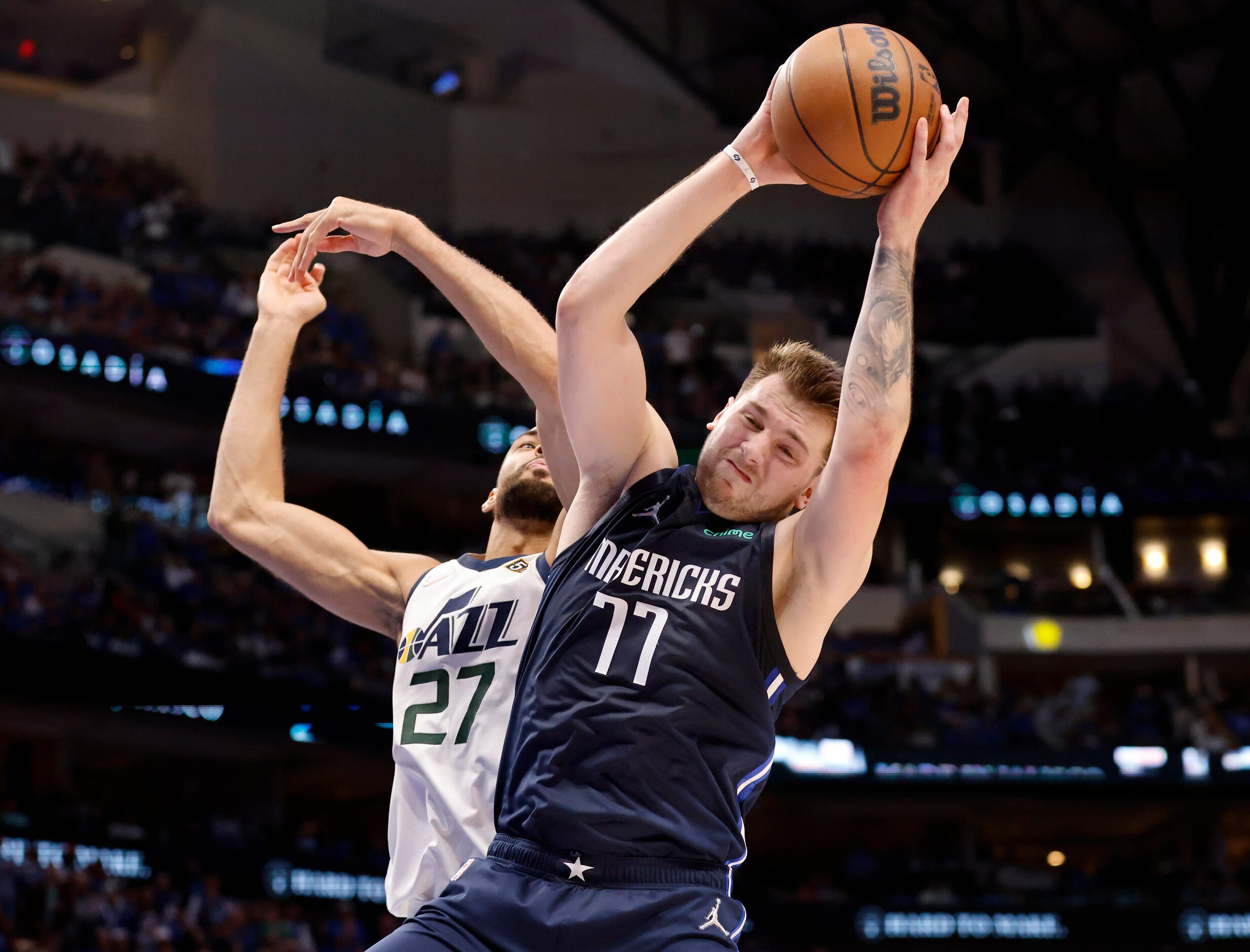 Dallas Mavericks guard Luka Doncic (77) battles for a defensive rebound against Utah Jazz...