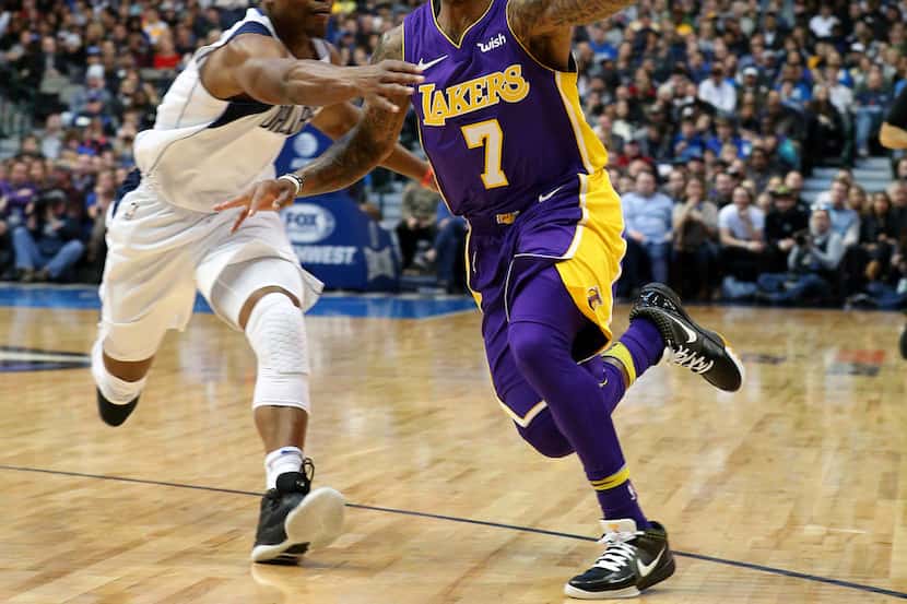 Los Angeles Lakers guard Isaiah Thomas (7) loses the ball as he drives to the basket against...