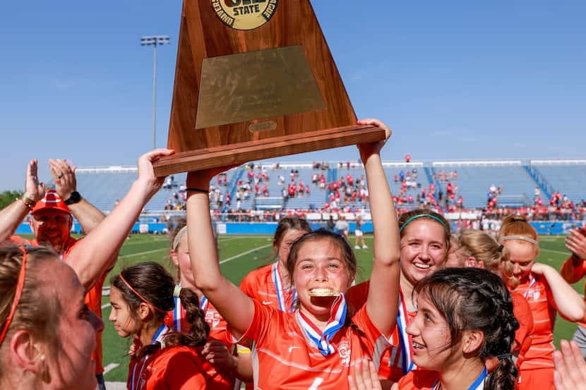Celina defender Makenna Brantley (4) raises the Class 4A girls soccer state championship...