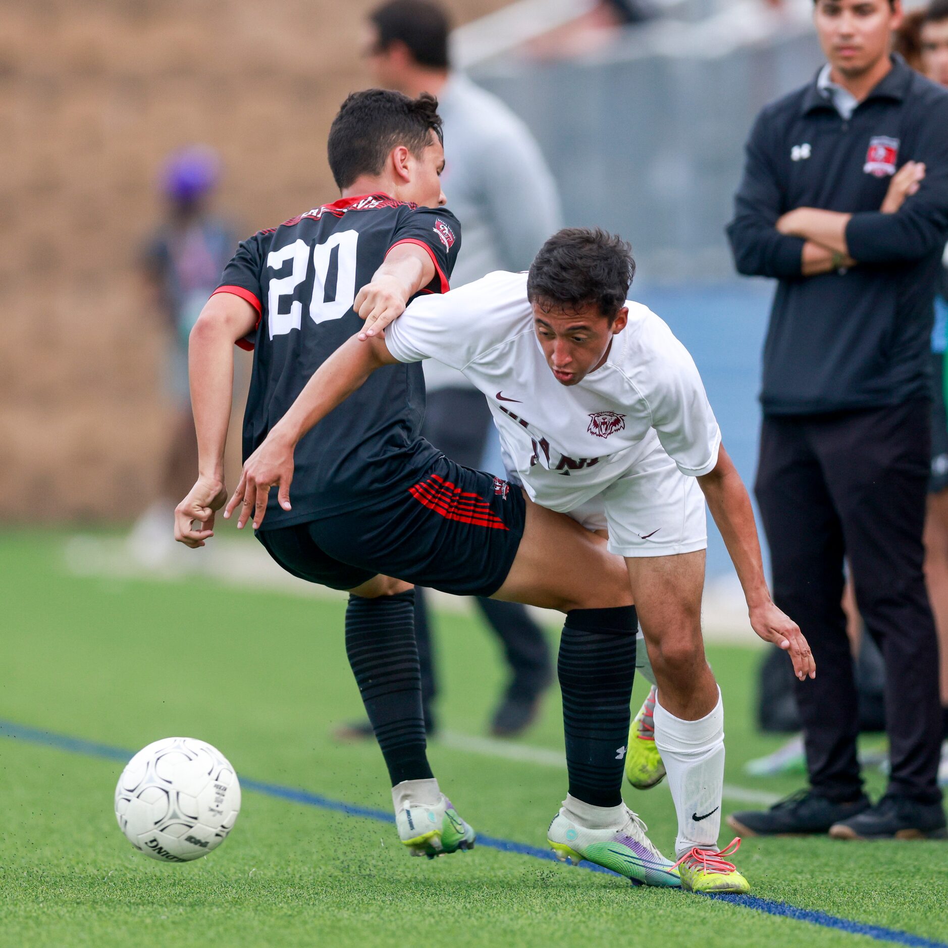 Austin Lake Travis forward Manuel Paez (20) tackles Plano midfielder Cristian Cifuentes (24)...