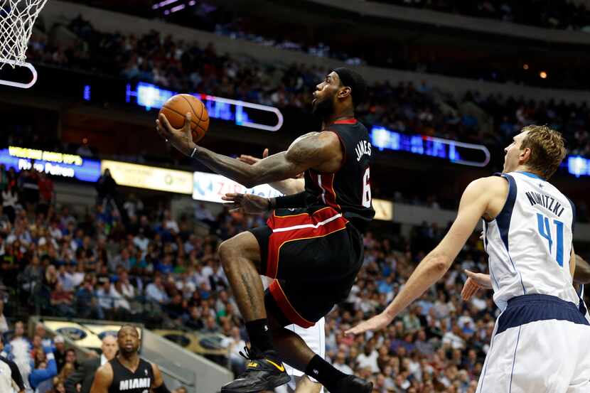 Miami Heat small forward LeBron James (6) drives past Dallas Mavericks power forward Dirk...