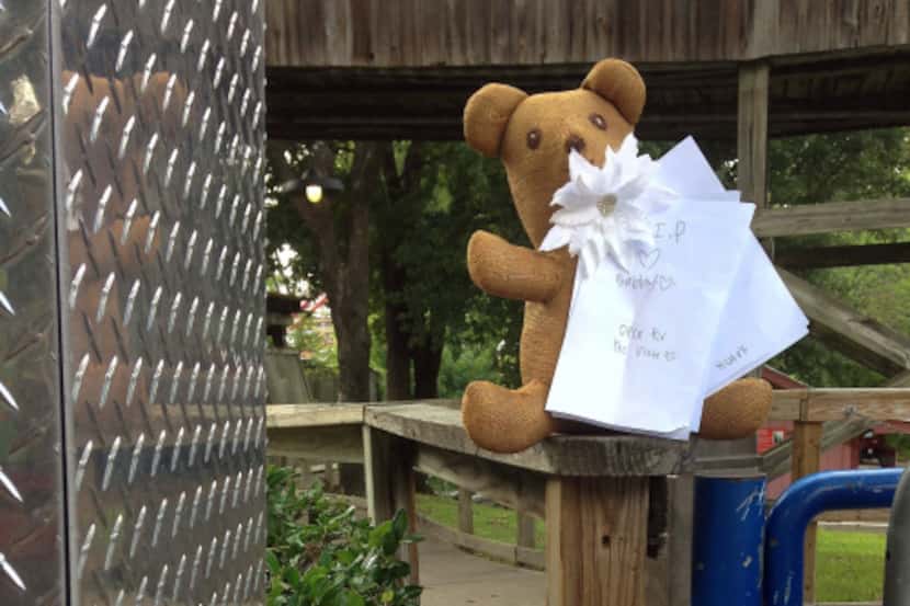 A teddy bear, flowers and notes were placed by the Texas Giant roller coaster's entrance on...