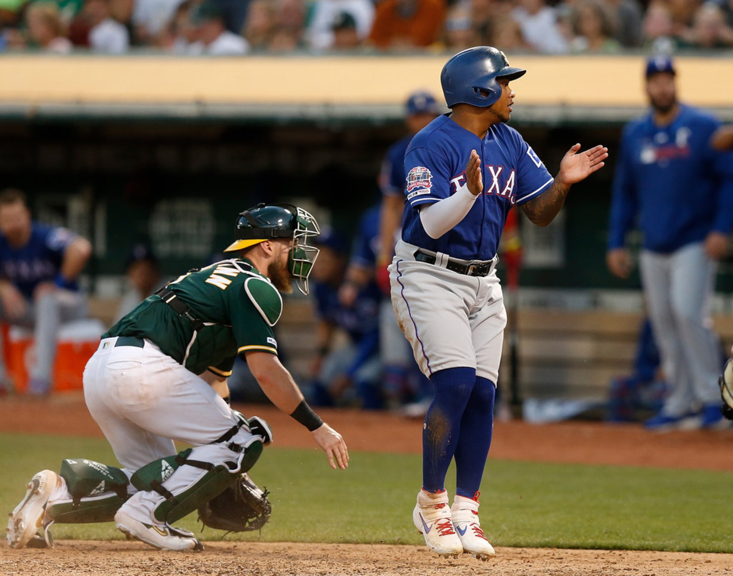 OAKLAND, CALIFORNIA - JULY 27: Willie Calhoun #5 of the Texas Rangers celebrates after...