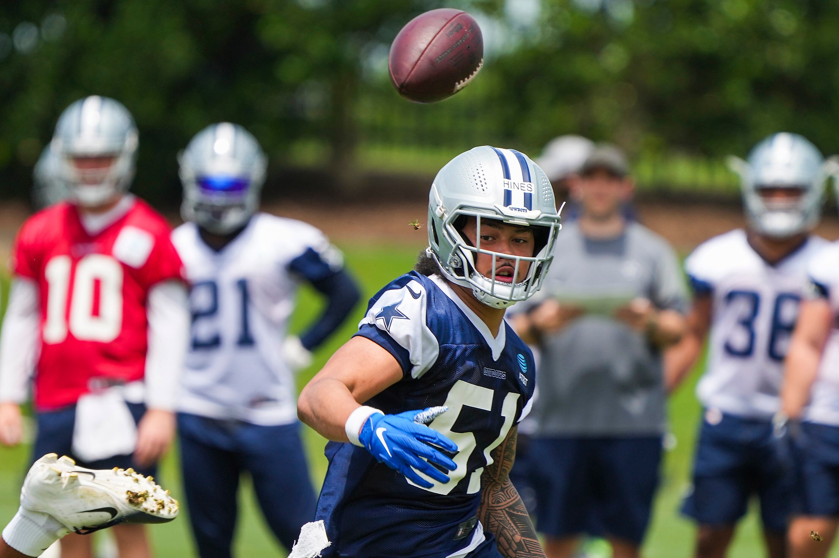 Dallas Cowboys linebacker Anthony Hines III reaches for a ball during a minicamp practice at...