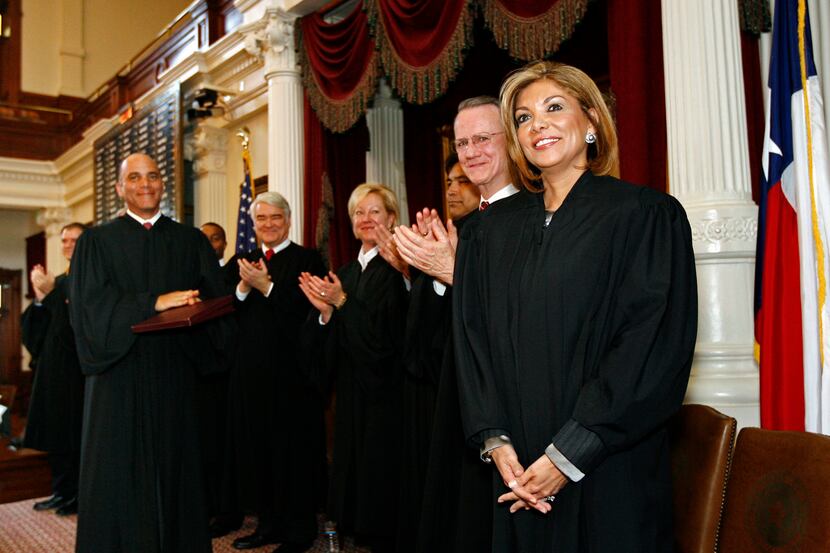Eva A. Guzman is congratulated by fellow justices after being  sworn into the Texas Supreme...