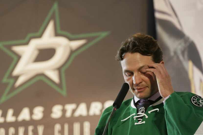  Dallas Stars' Brenden Morrow pauses to compose himself as he speaks during his retirement...