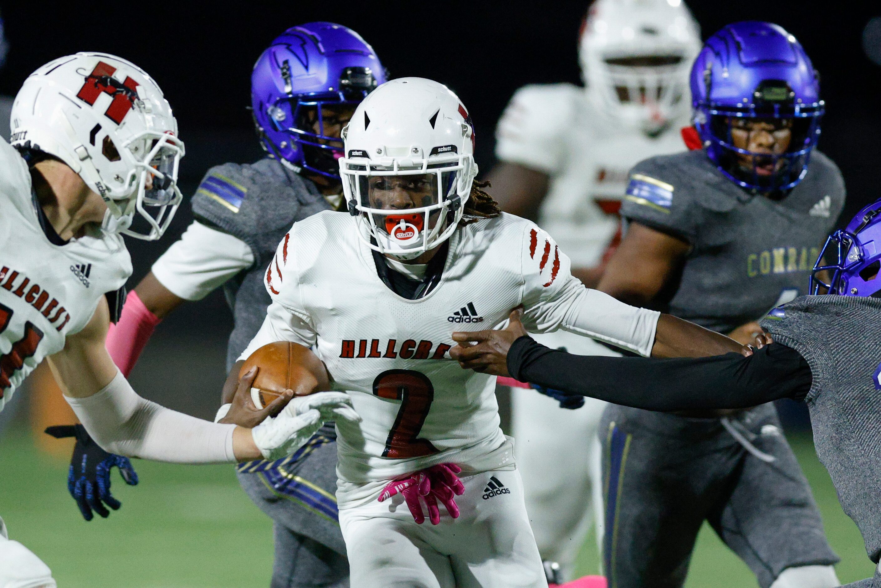 Hillcrest running back Reggie Williams (2) stiff-arms Conrad  wide receiver Christian Byrum...