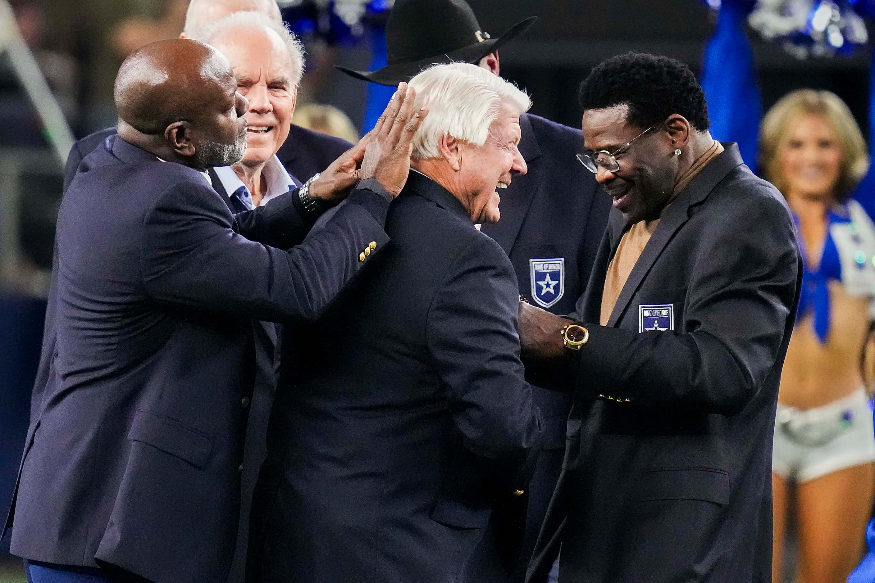 Former players Emmitt Smith and Michael Irvin help Dallas Cowboys head coach Jimmy Johnson...